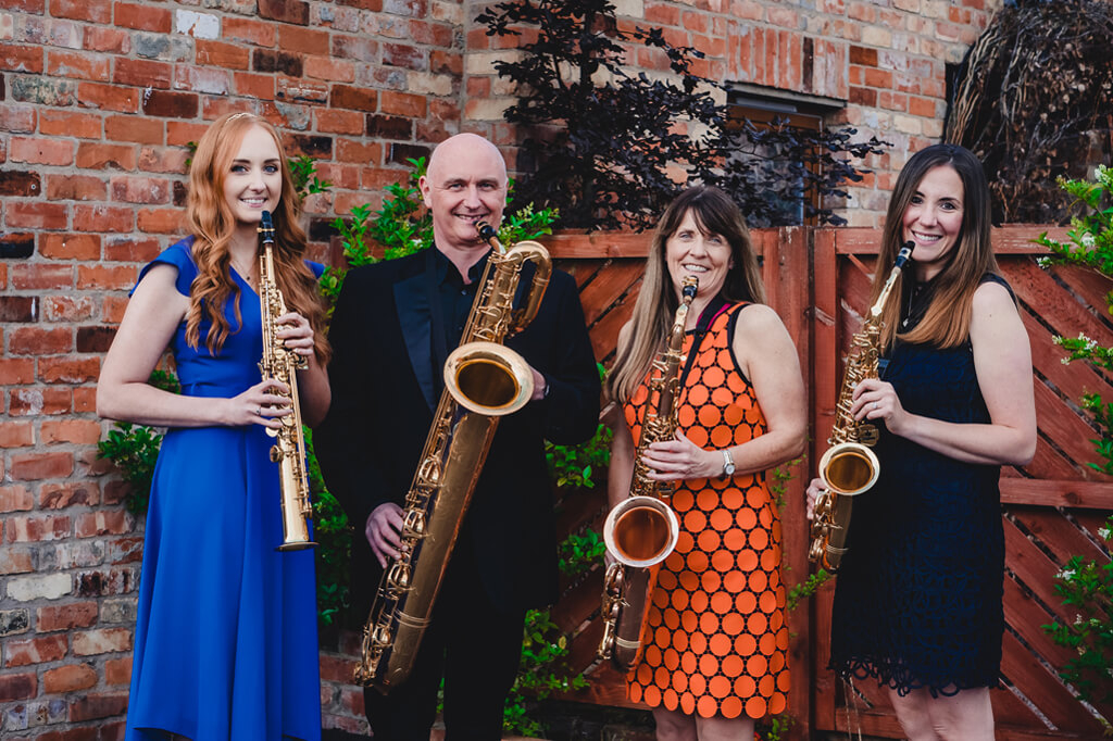 NI Saxophone Quartet together posed with saxes
