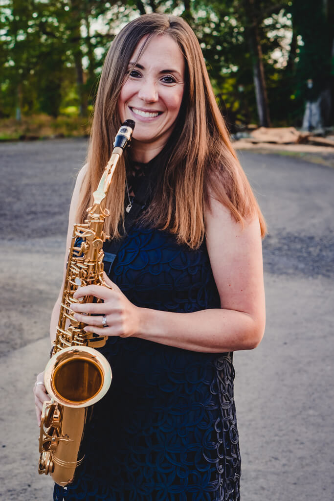 Jenna of NI Saxophone Quartet closeup promotional image colour with sax
